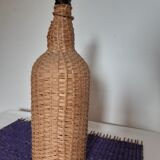 Old high wicker glass bottle