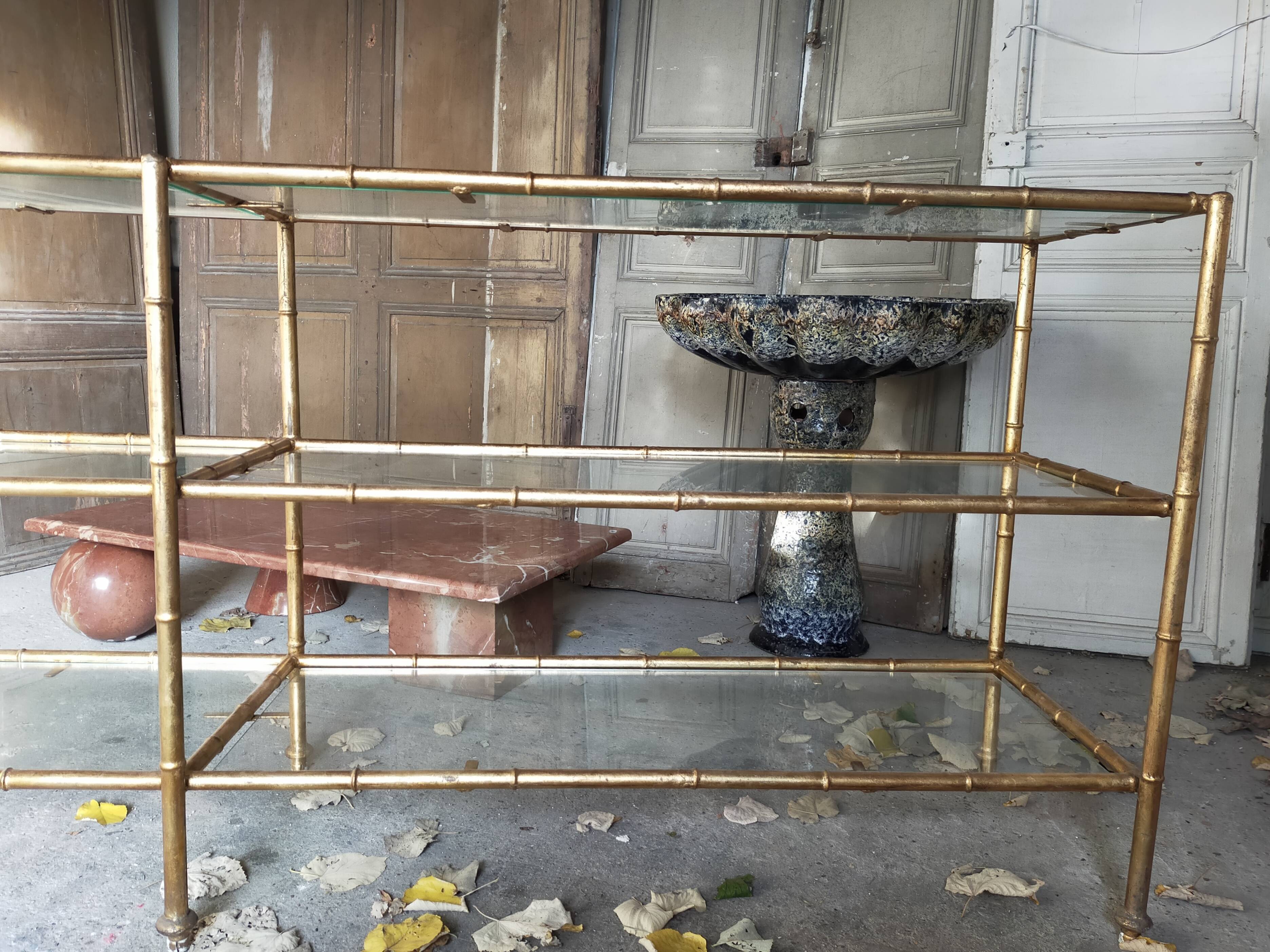 Console in gilded metal and glass