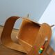 Baumann Baby Coquille children's armchair in bent wood with splayed legs.