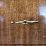 1950s chest of drawers covered in walnut with brass handles