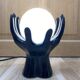 Sculpted ceramic globe lamp.