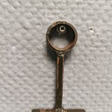 Wall-mounted candle holder in cast iron and hard pressed blue glass.