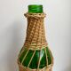 bouteille entourée de rotin années 70