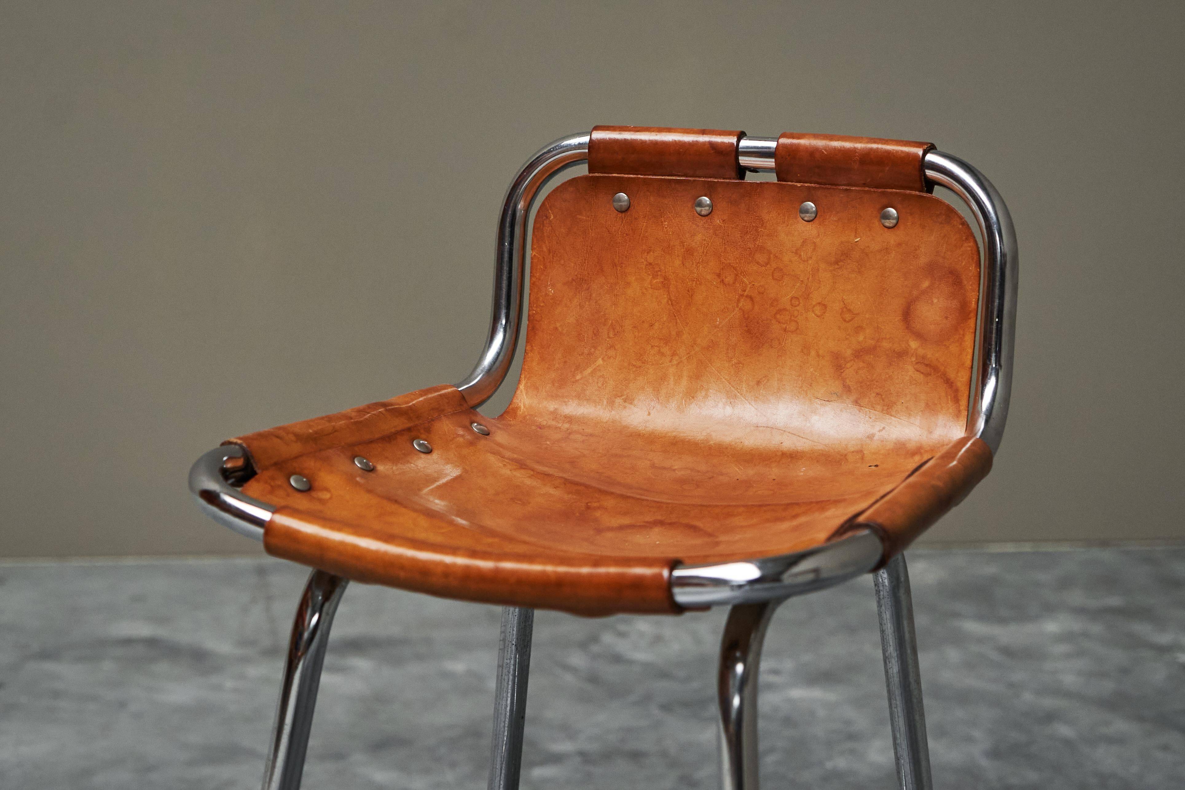 Set of 2 stools "Les Arcs" selected by Charlotte Perriand in leather.
