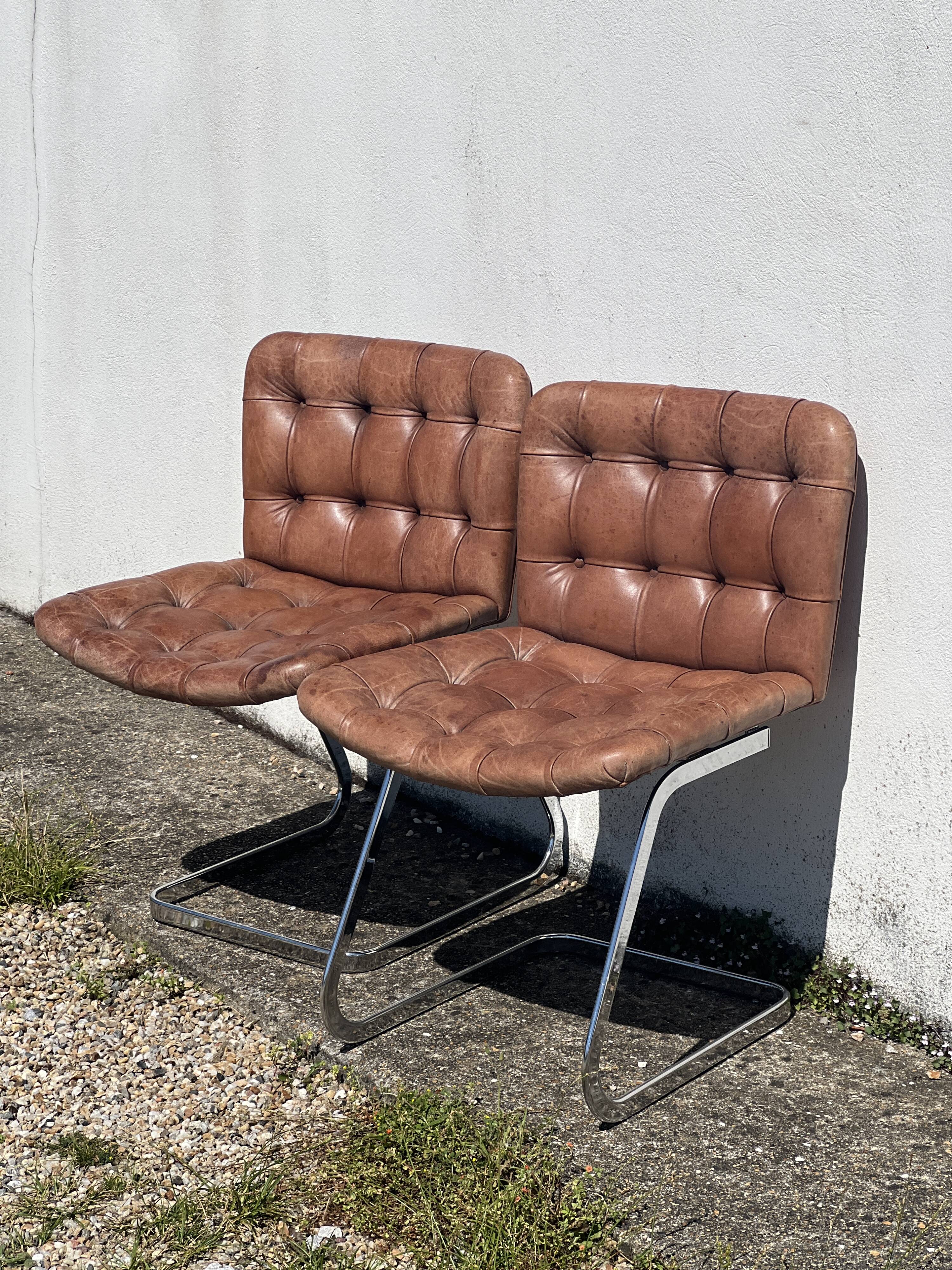Pair of leather chairs by Robert Haussman
