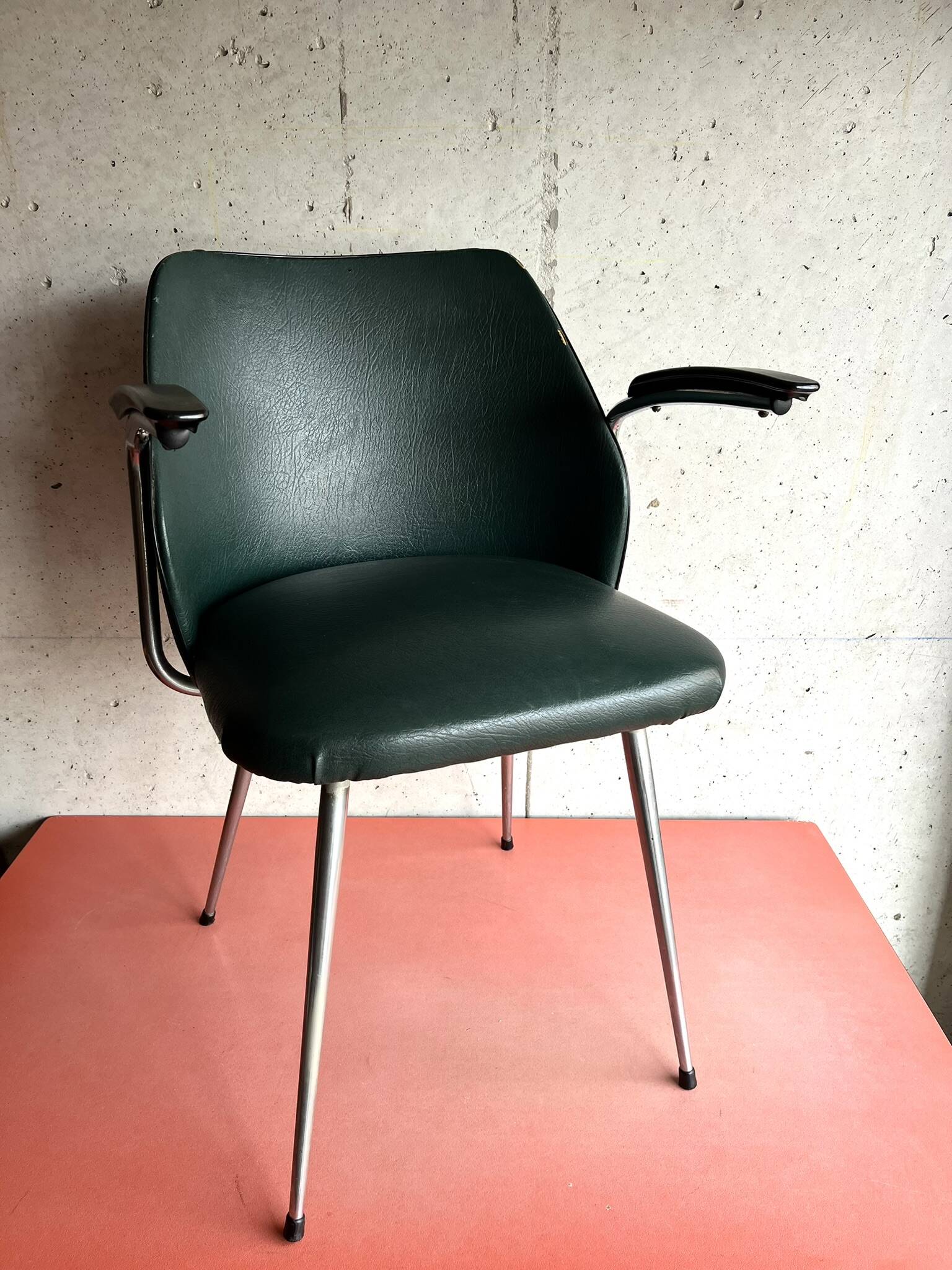 Vintage green faux leather and chrome armchair