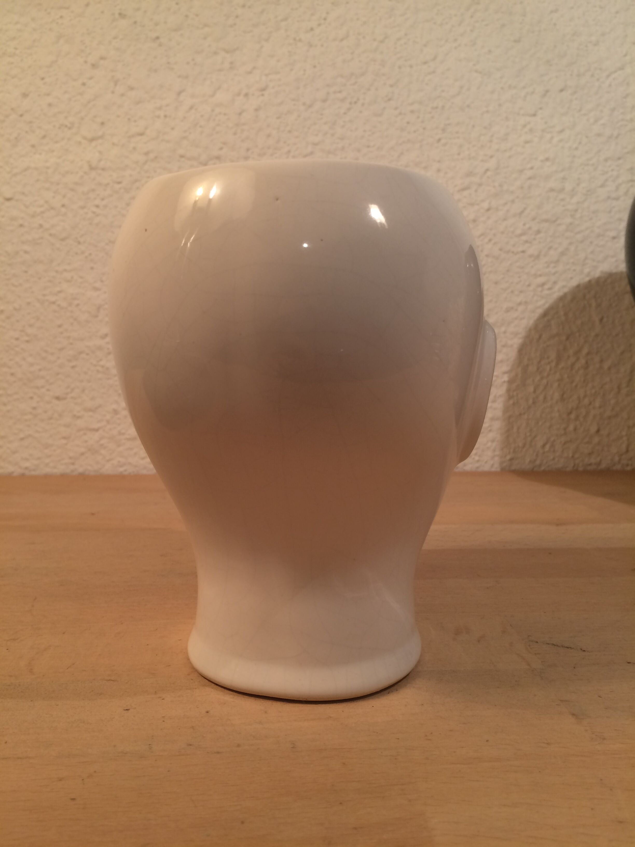 2 black and white ceramic head vases, face