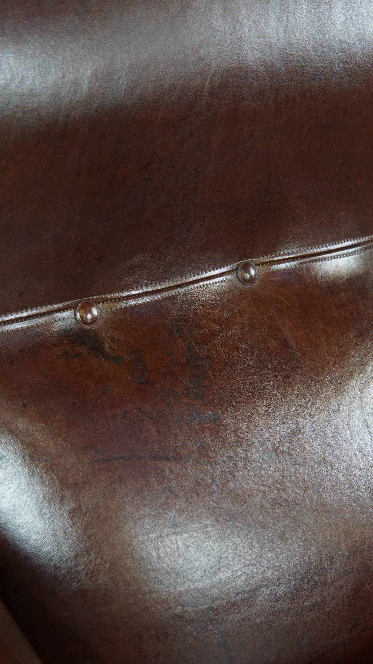 Comfortable and correct dark antique sheepskin English armchair in very good condition