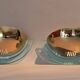 Pair of gold metal and plexiglass wall lights, circa 1980.
