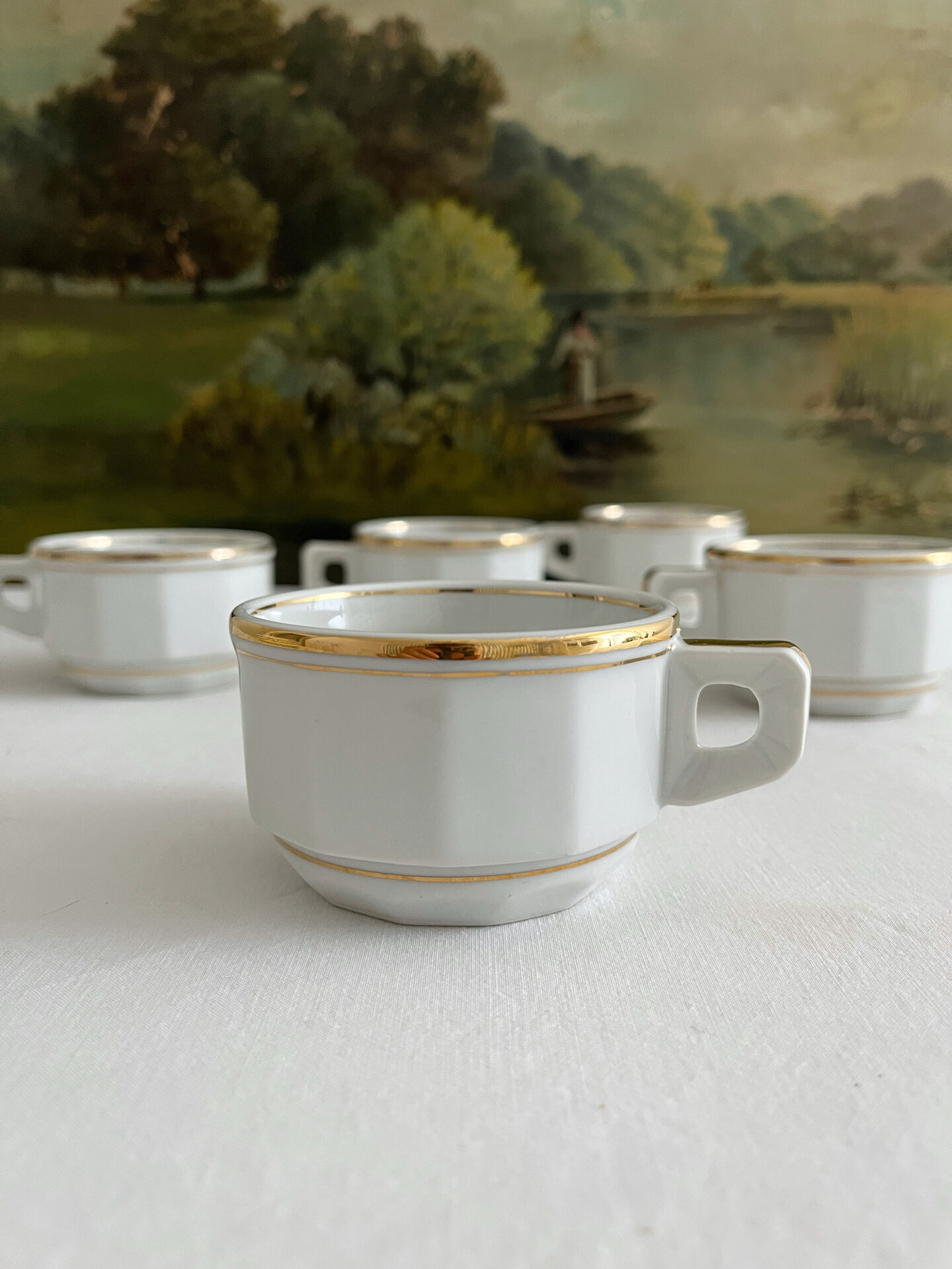 5 vintage porcelain bistro coffee cups from Paris with gold trim.
