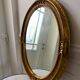 Grand miroir oval en stuc doré vintage