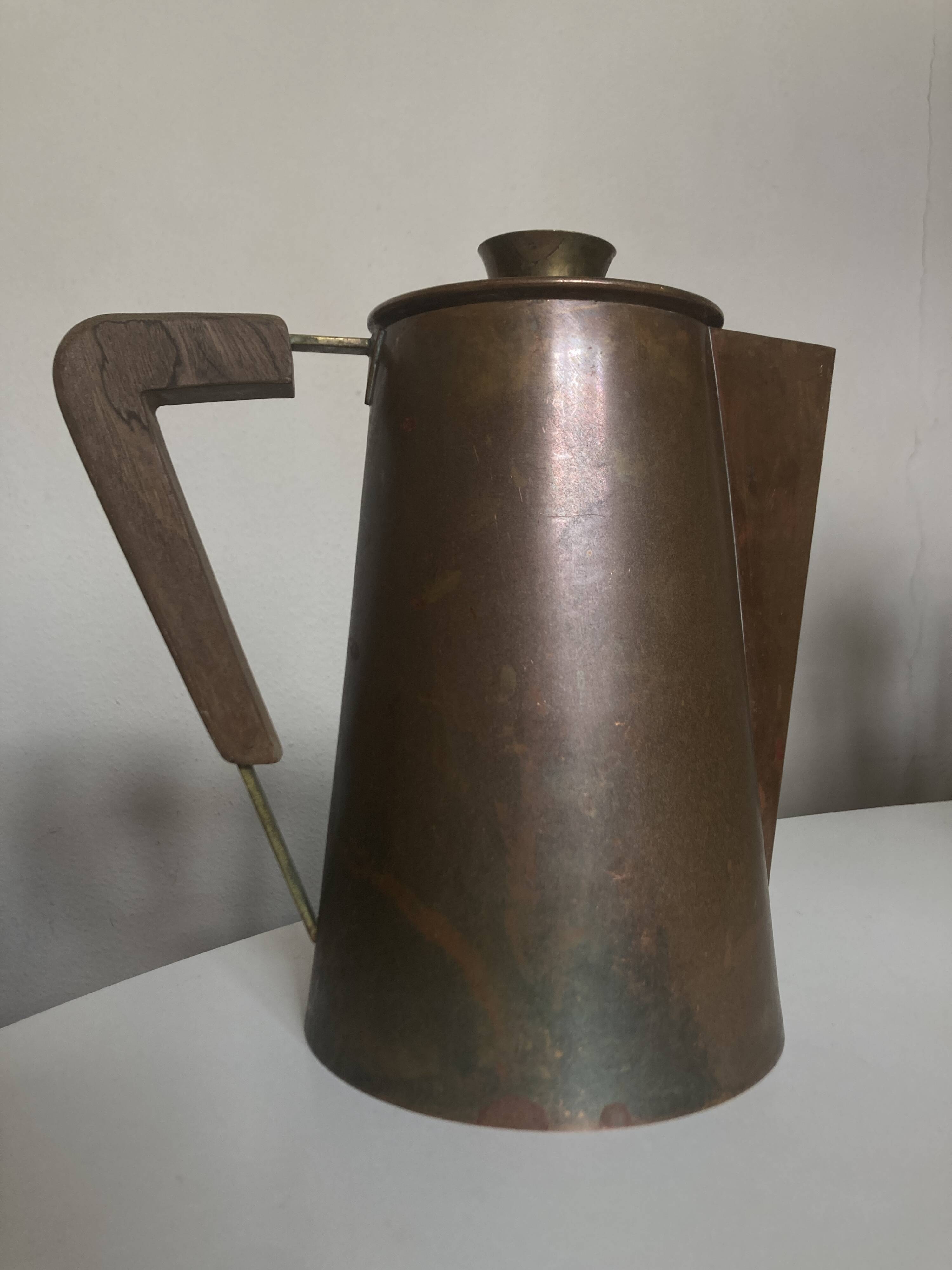 Modernist Italian pitcher design from the 1960s in patinated wood and metal.