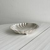 Old metal plate in the shape of a shell.