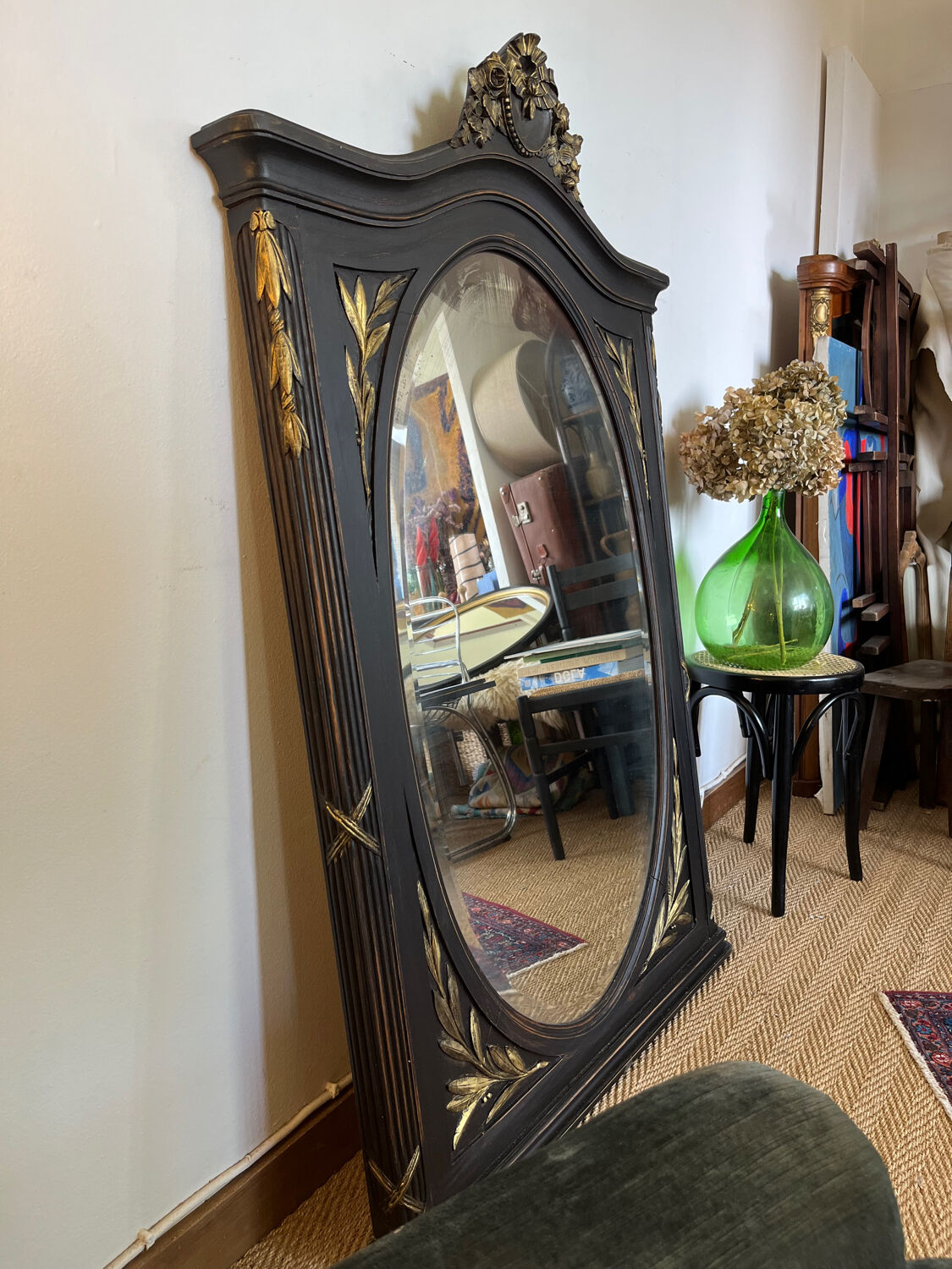 Large old trumeau mirror in black and gilded wood Napoleon style