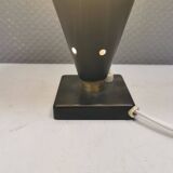 Small stylish table lamp with perforations and milky white opal glass shade