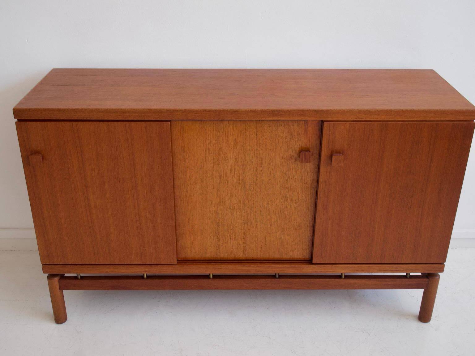 Modern mid-century teak sideboard with brass details.