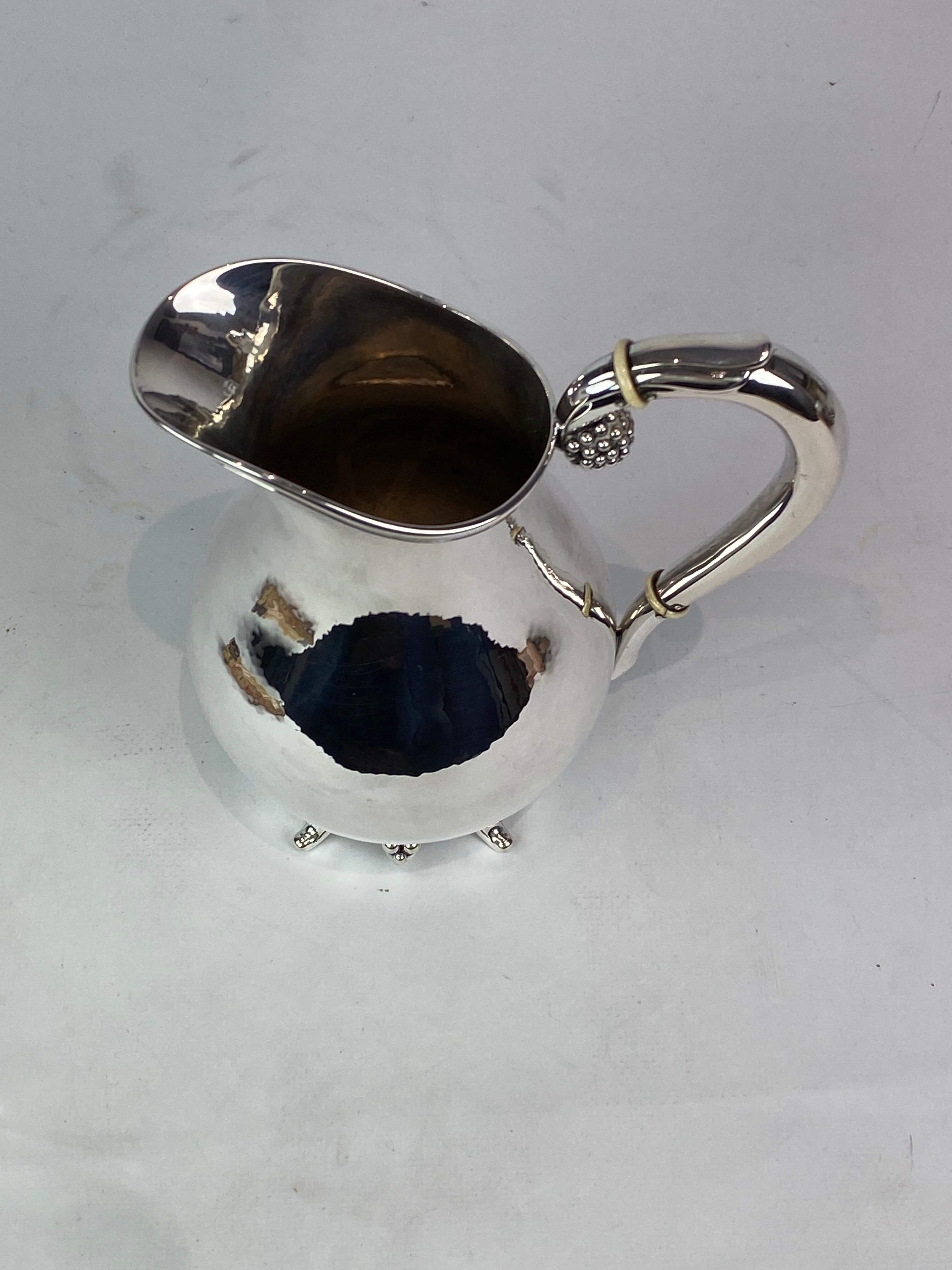 Water jug on feet decorated with ebony of hallmarked silver from the 1940s. The jug is in great anti