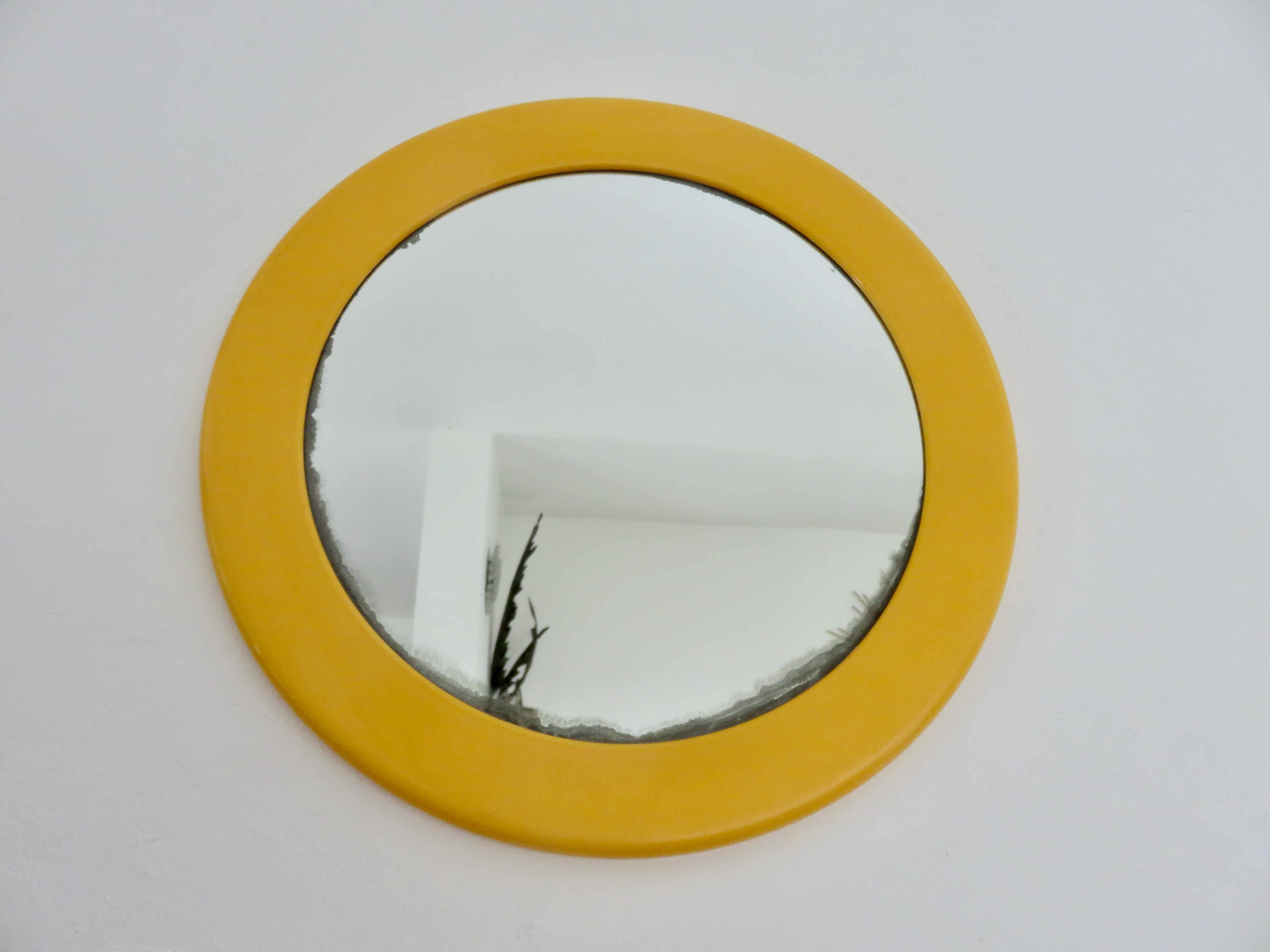 Round wall mounted mirror in yellow plastic 1970