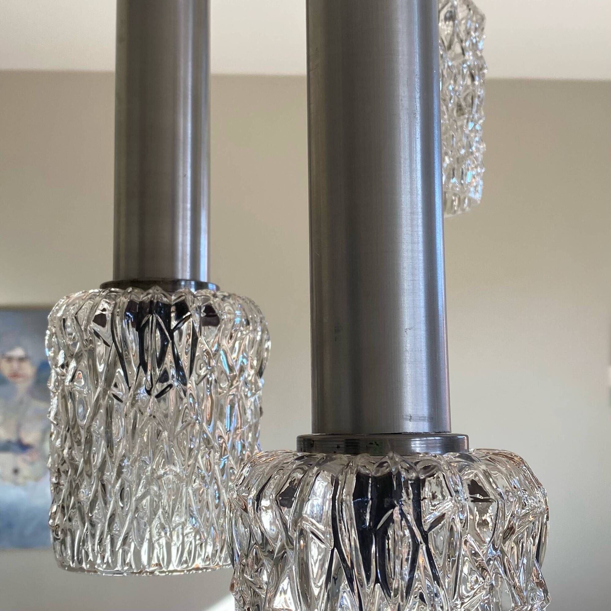 Large cascading chandelier with 5 glass lampshades and aluminium tube.