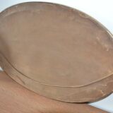 Old oval beveled wooden mirror, partly gilded and carved