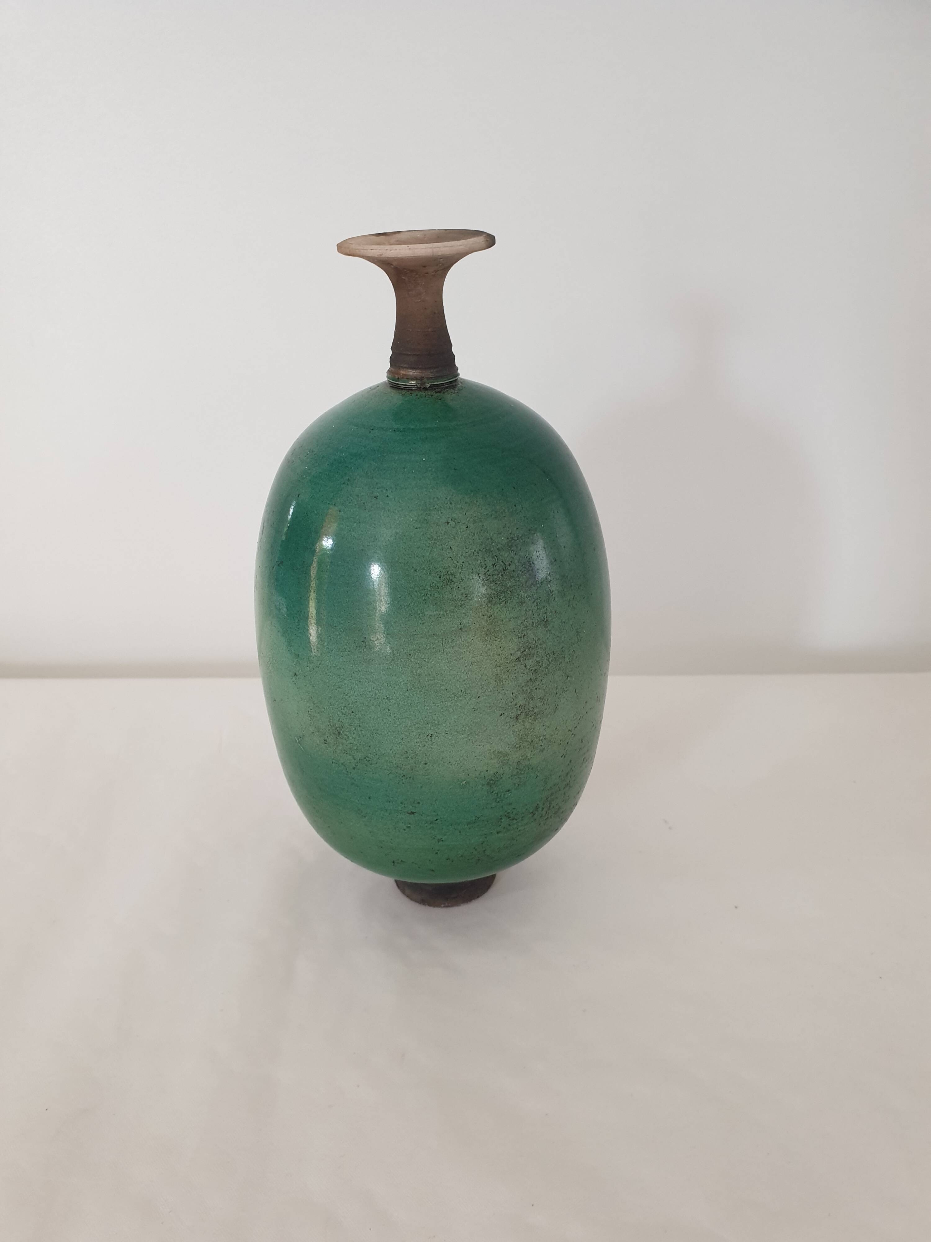 Green pot-bellied ceramic vase with foot and high, narrow neck in signed raku