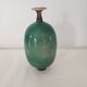 Green pot-bellied ceramic vase with foot and high, narrow neck in signed raku