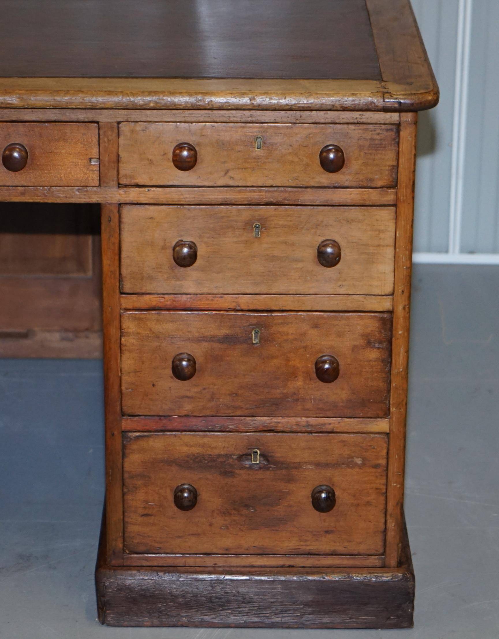 Antique Victorian oak kneehole desk with 18 double-sided drawers.