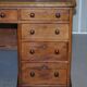 Antique Victorian oak kneehole desk with 18 double-sided drawers.