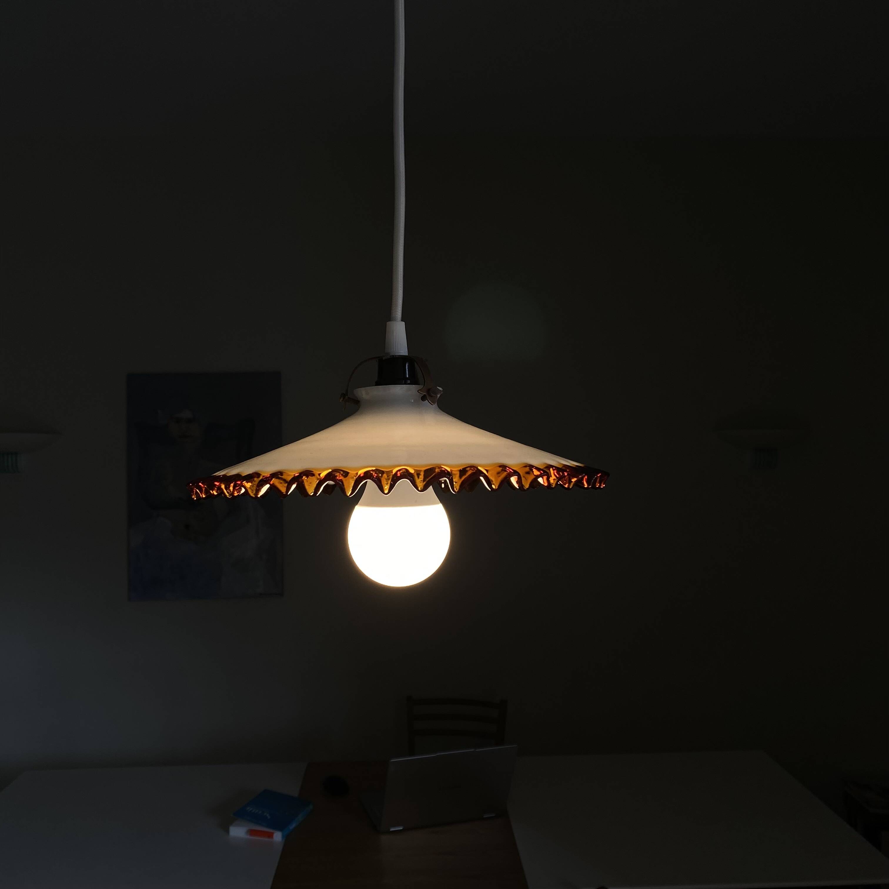 Old pendant light with a white opaline glass shade and a wavy border.