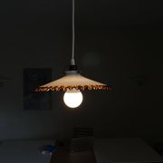 Old pendant light with a white opaline glass shade and a wavy border.