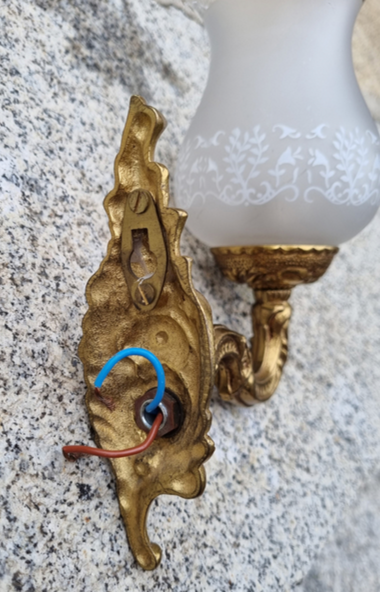 Pair of bronze wall lamps and frosted glass globe, early twentieth century.