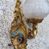 Pair of bronze wall lamps and frosted glass globe, early twentieth century.