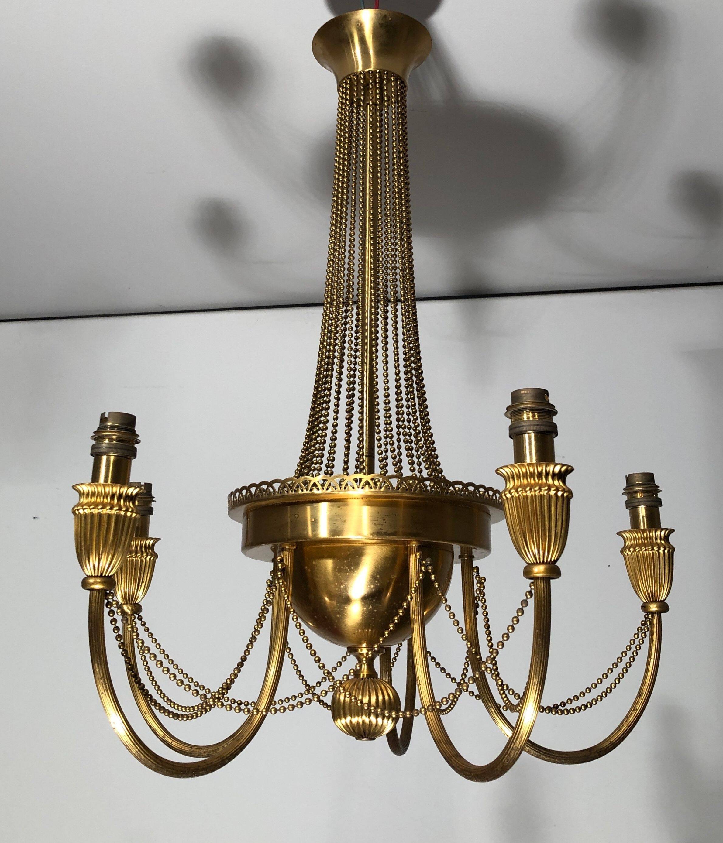 Neoclassical style brass chandelier decorated with pearl garlands