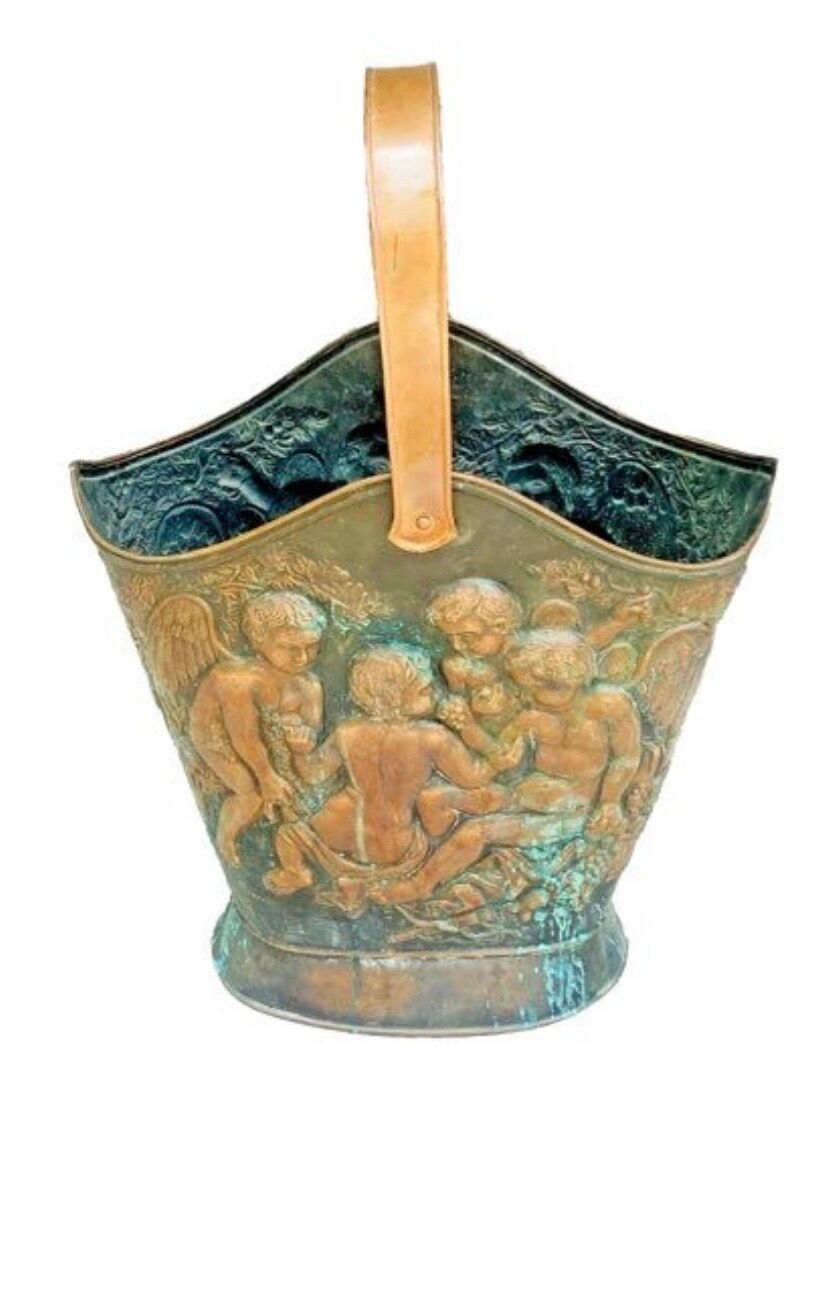 Antique red copper umbrella stand decorated with putti angels.