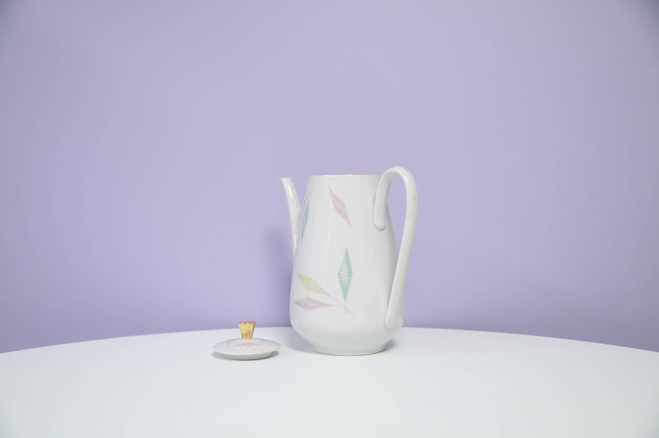 White teapot with pastel flowers