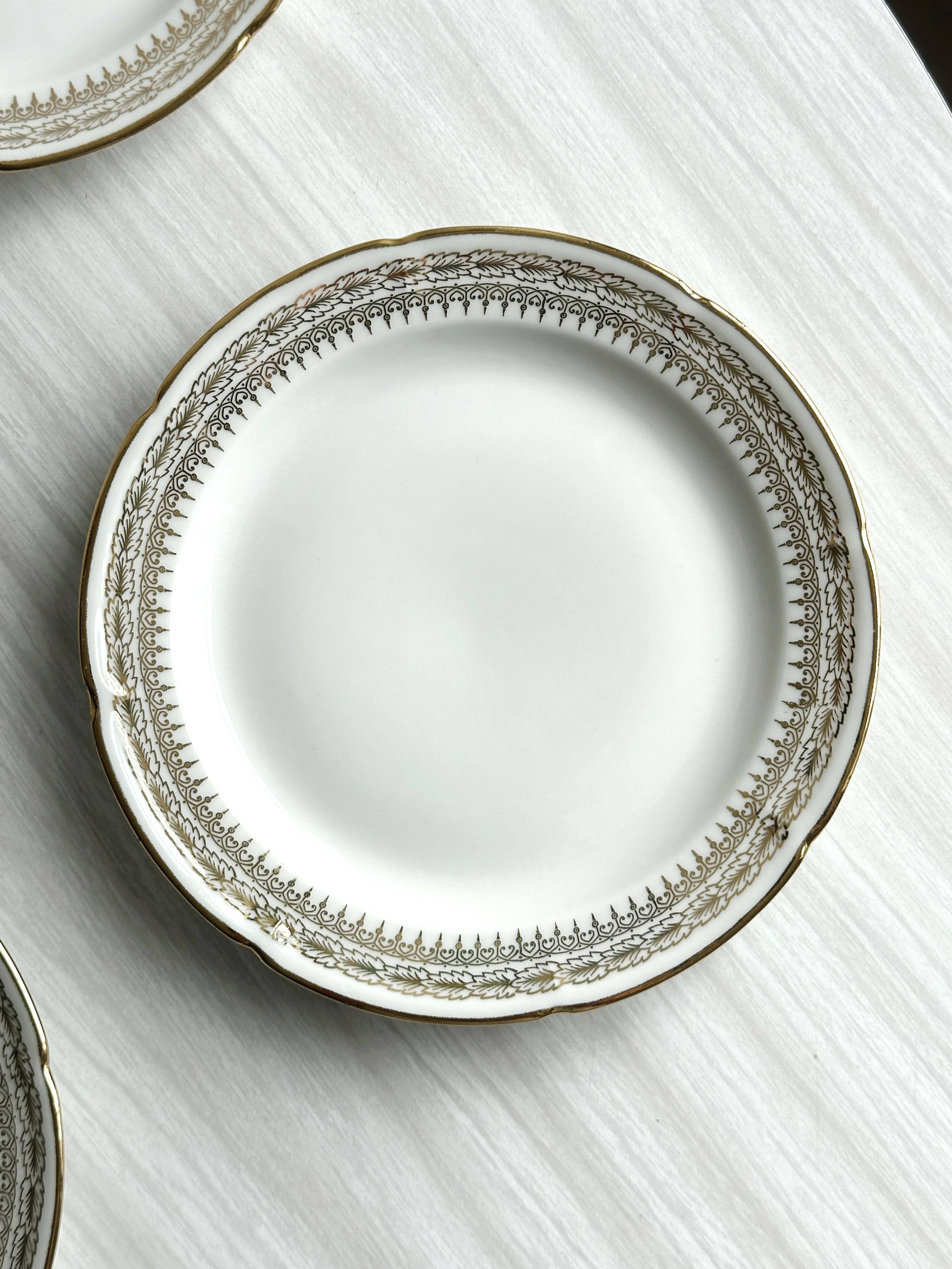 12 Limoges porcelain dessert plates, gold decoration.