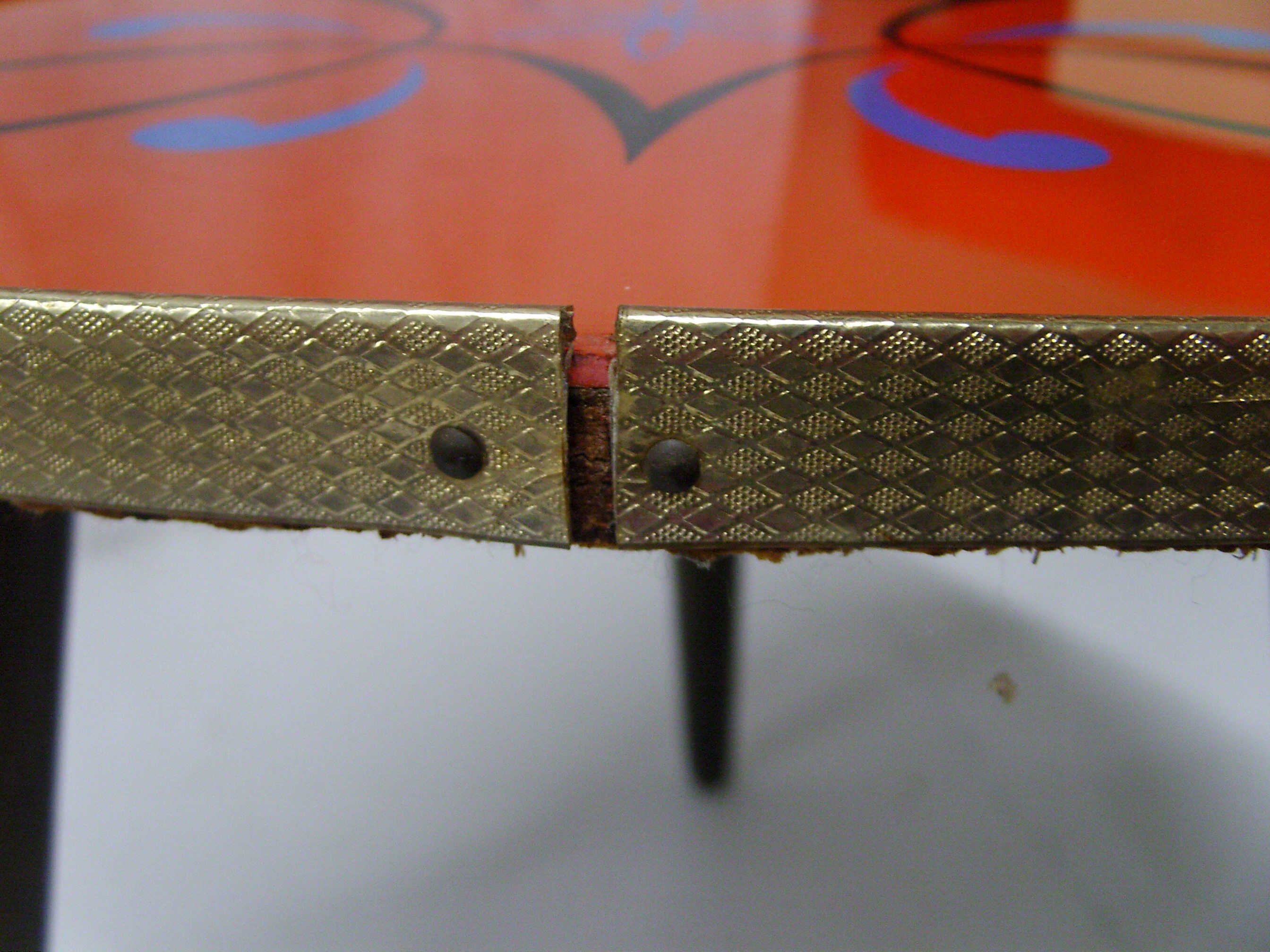 Plant holder tripod in geometrically patterned orange formica