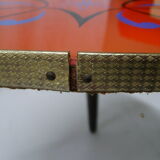 Plant holder tripod in geometrically patterned orange formica