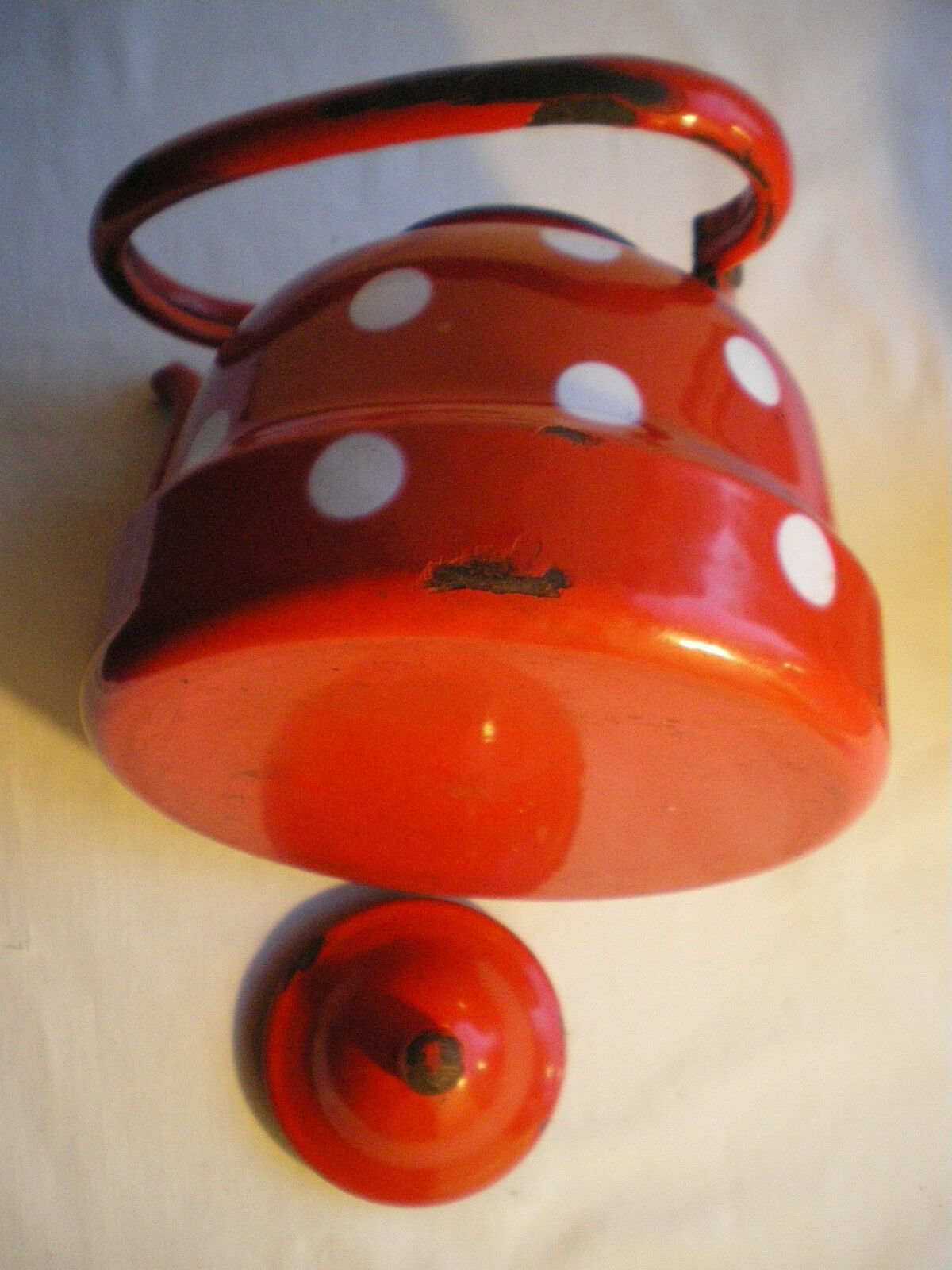 Vintage kettle in red enamelled sheet with white polka dots