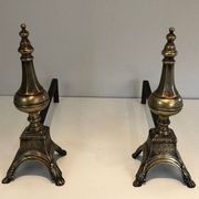 Pair of chiselled bronze and wrought iron fire dogs in the Louis XVI style.