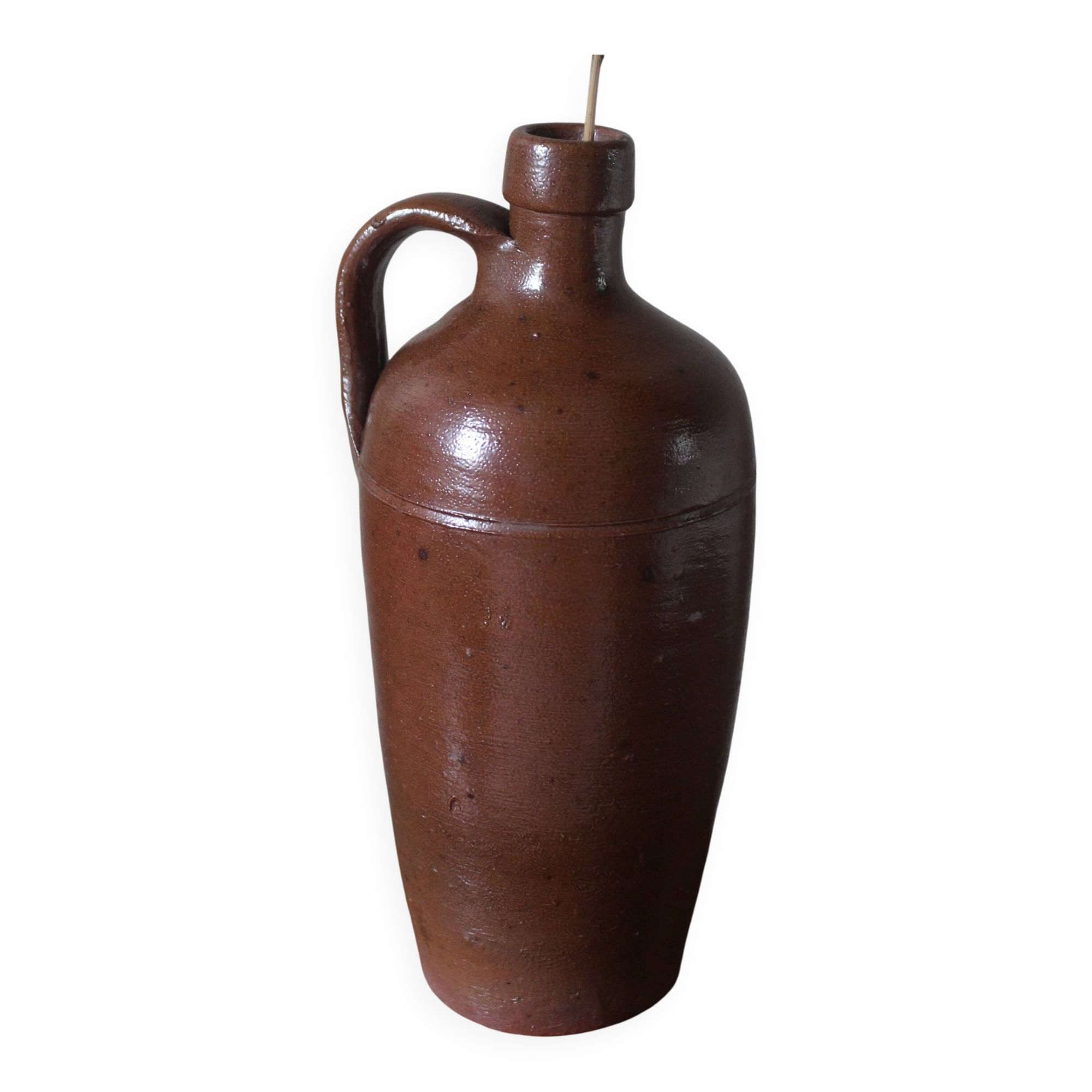 Vintage stoneware liqueur bottle with handle and spout.