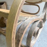 Rocking chair with a cane seat and backrest.