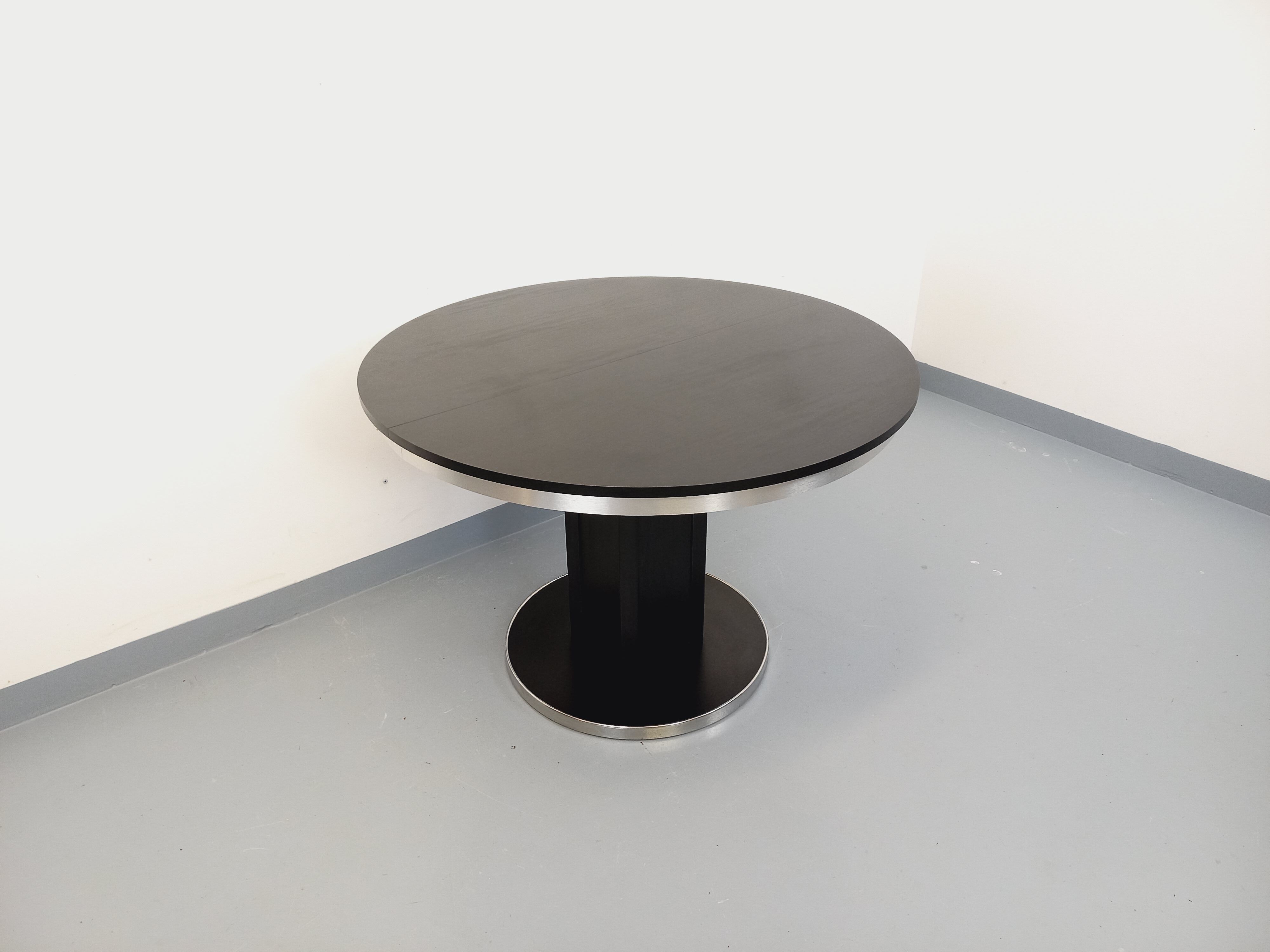 Vintage dining table in melamine with a black wood effect and chrome metal.