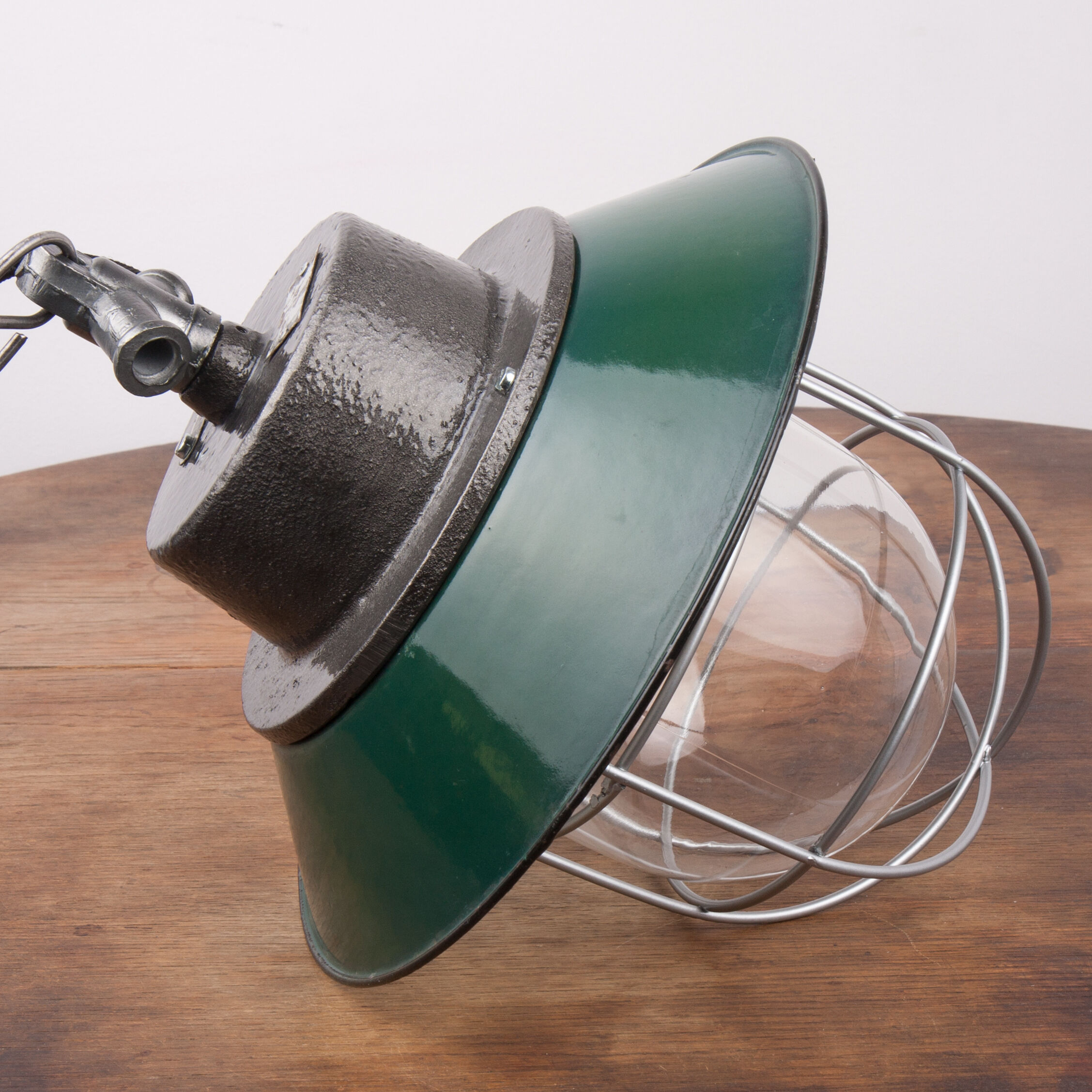 Industrial enamel lamp with glass and cast iron, opal  green, Poland, 1960s