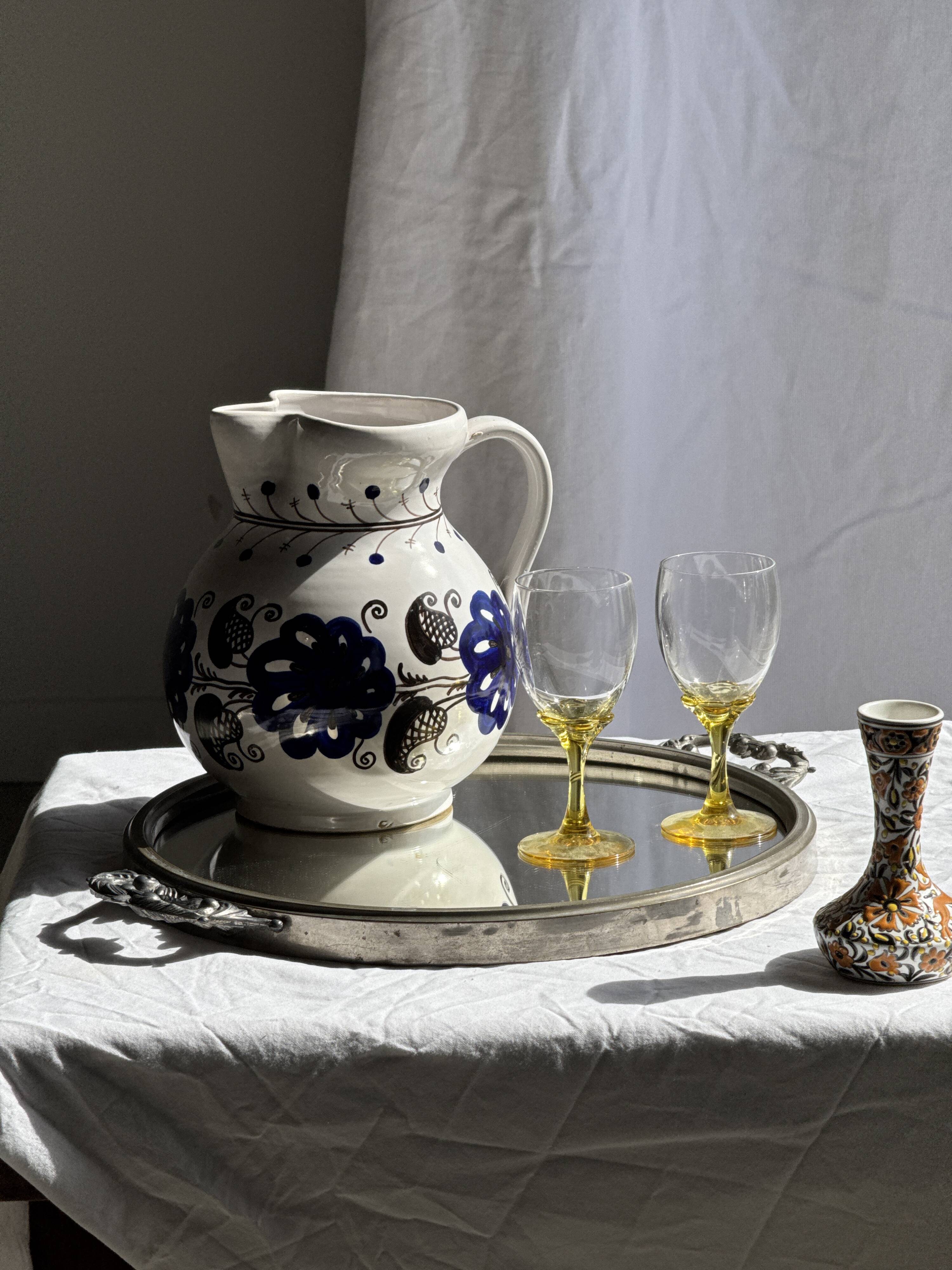 Very large vintage ceramic carafe in white glazed with blue floral decoration.