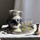 Very large vintage ceramic carafe in white glazed with blue floral decoration.