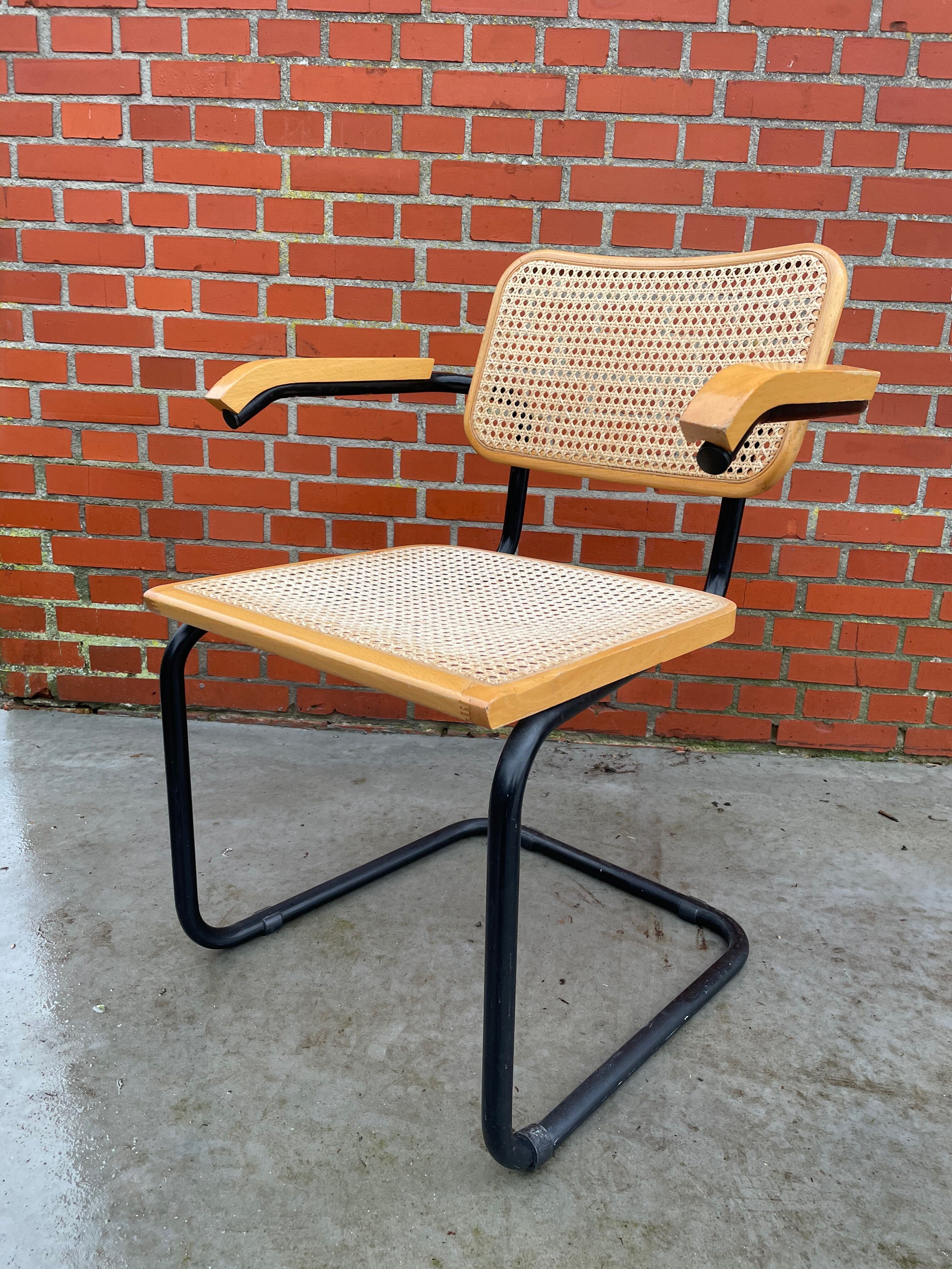Cesca model chair designed by Marcel Breuer with black-framed armrests