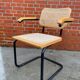 Cesca model chair designed by Marcel Breuer with black-framed armrests