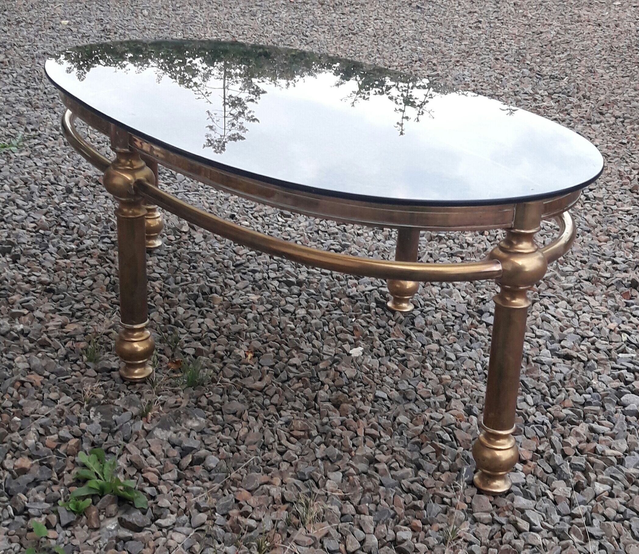 Oval coffee table in gilded brass and smoked glass 1970