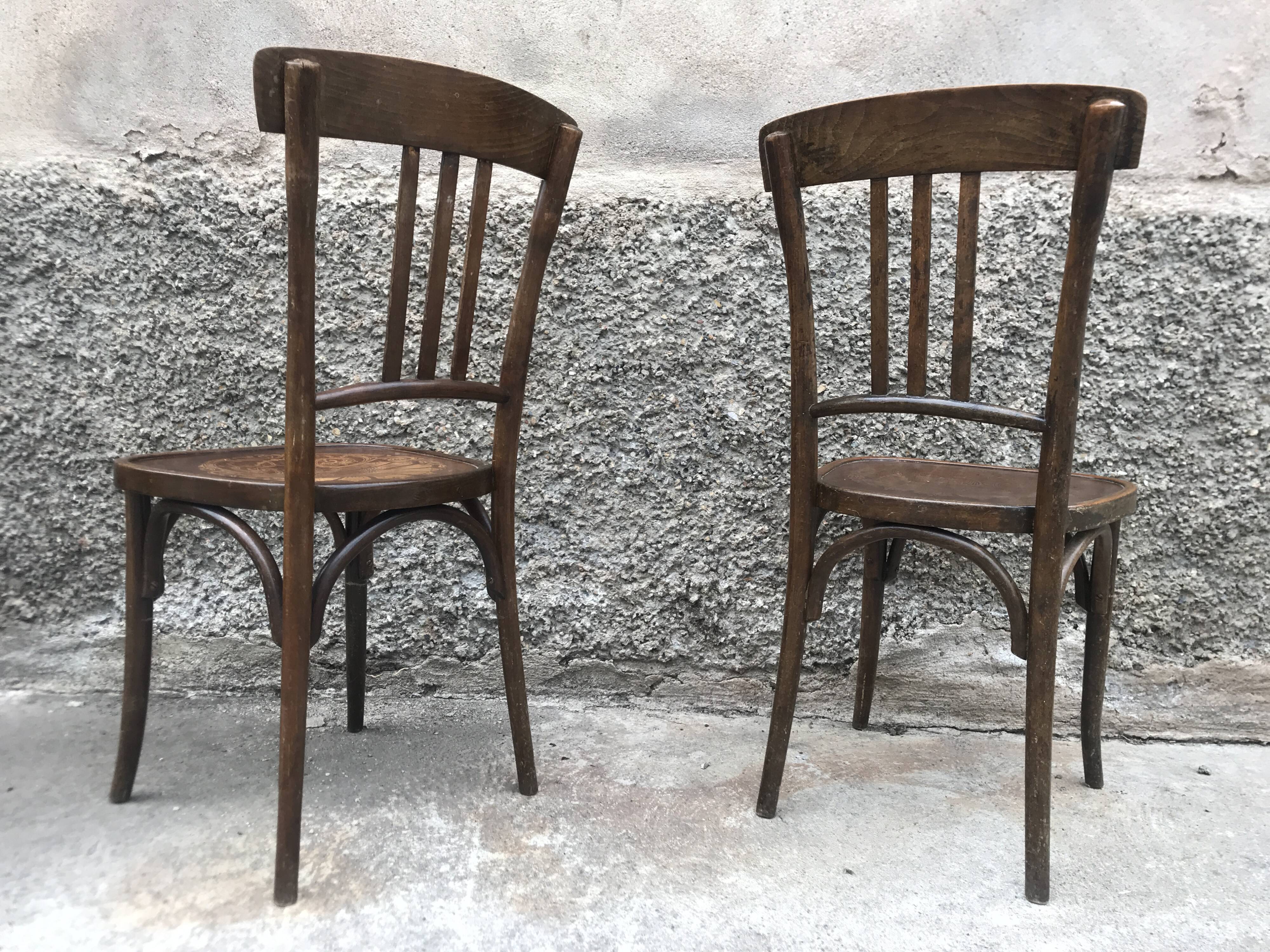 Pair of brasserie bistro chairs with seashell on seat